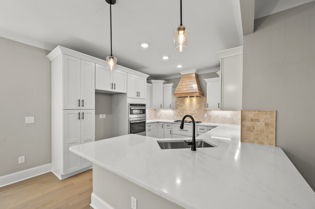 543 Barrett Road, photo of the kitchen with counter top bar space, double oven and beautiful custom cook top.