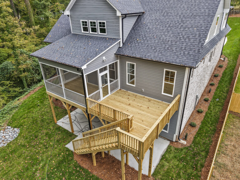 543 Barrett Road, photo of the rear of home with back deck and screened in porch.
